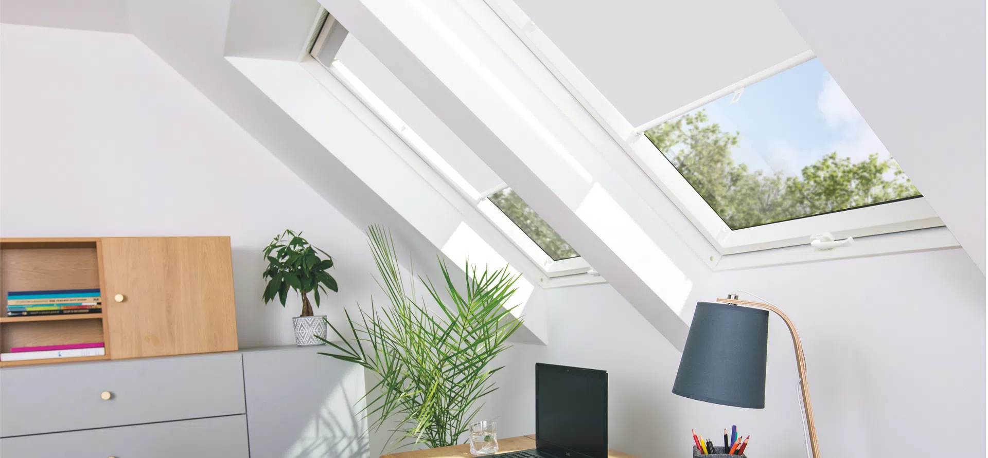 uPVC white roof window pre-fitted with a white roller blind